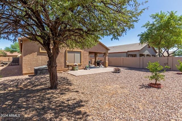 back of house featuring a patio area and an outdoor fire pit