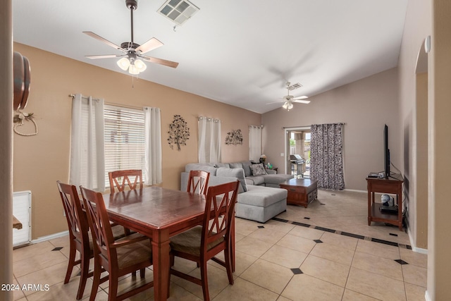 tiled dining area with vaulted ceiling and ceiling fan