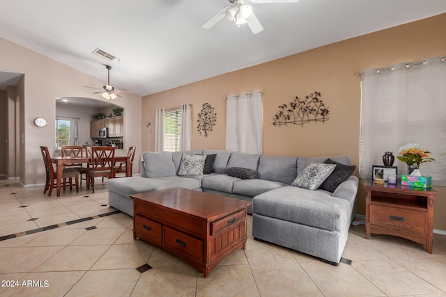 tiled living room featuring vaulted ceiling and ceiling fan