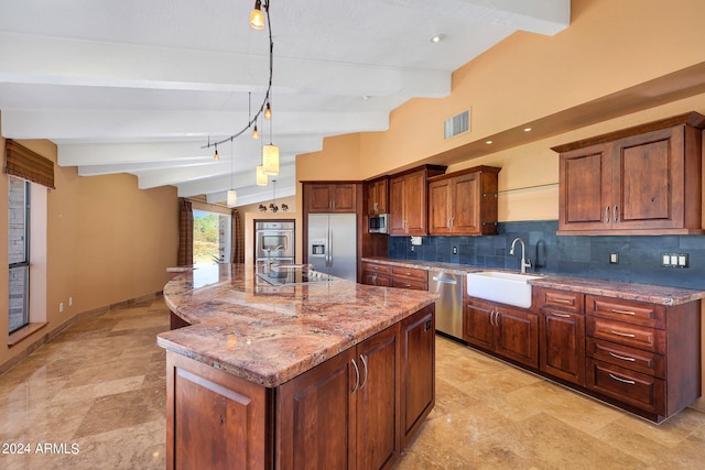 kitchen featuring appliances with stainless steel finishes, sink, pendant lighting, lofted ceiling with beams, and a center island