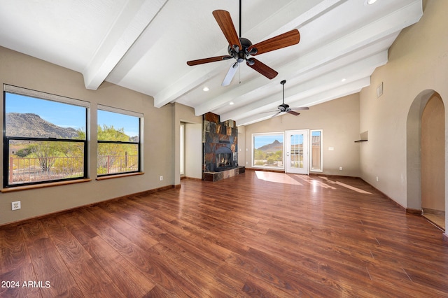 unfurnished living room with a mountain view, lofted ceiling with beams, dark hardwood / wood-style floors, and ceiling fan