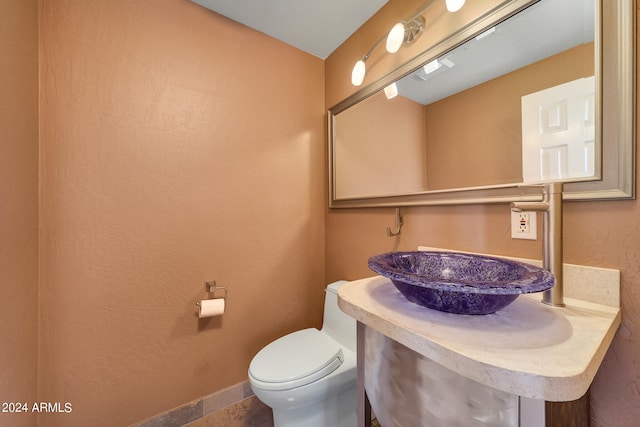 bathroom featuring tile patterned floors, sink, and toilet