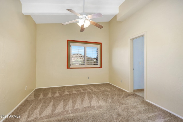 spare room with vaulted ceiling with beams, carpet floors, and ceiling fan