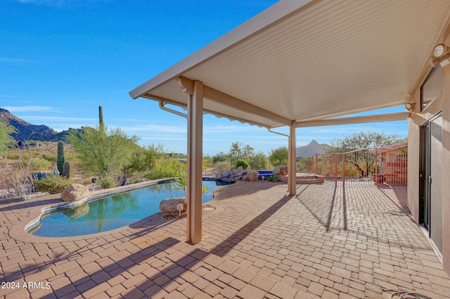 view of pool featuring a mountain view and a patio