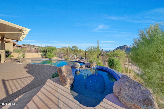 view of swimming pool with a mountain view and a patio