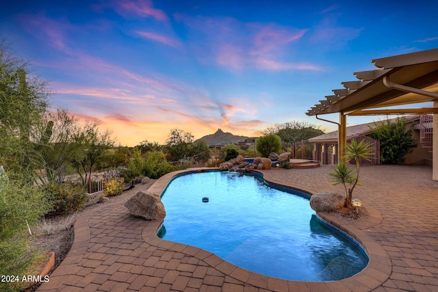 pool at dusk with a patio