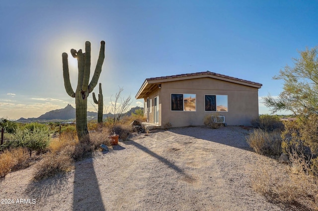 view of property exterior with a mountain view