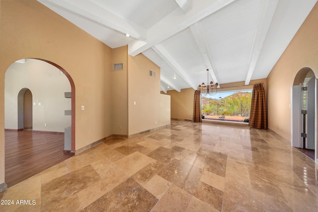 unfurnished living room with beam ceiling and a notable chandelier