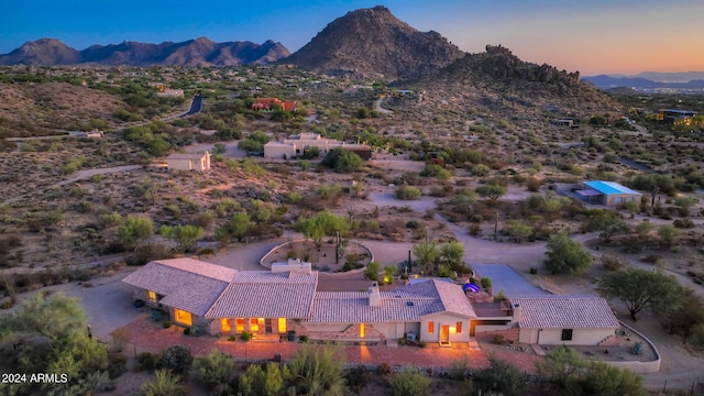 aerial view at dusk featuring a mountain view