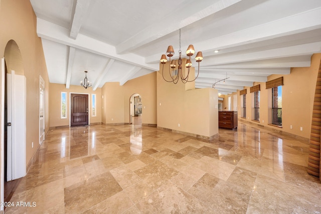 interior space featuring vaulted ceiling with beams and an inviting chandelier