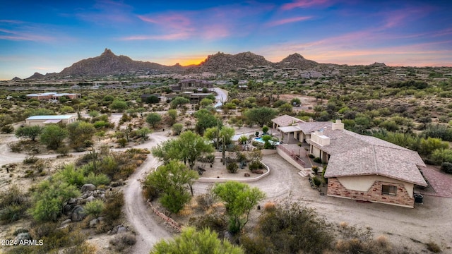 aerial view at dusk featuring a mountain view