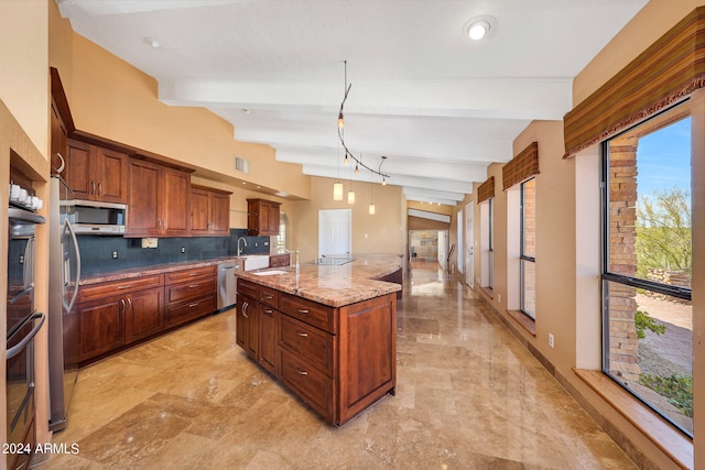 kitchen with light stone countertops, backsplash, stainless steel appliances, beam ceiling, and an island with sink