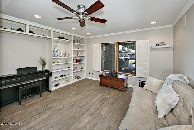 living area with dark wood-type flooring, ornamental molding, and ceiling fan