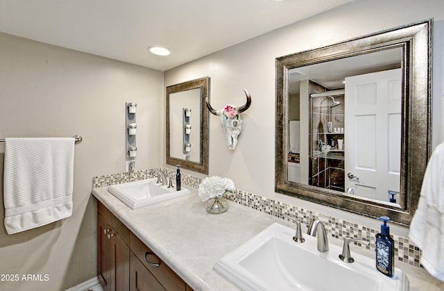 bathroom featuring tasteful backsplash, vanity, and walk in shower