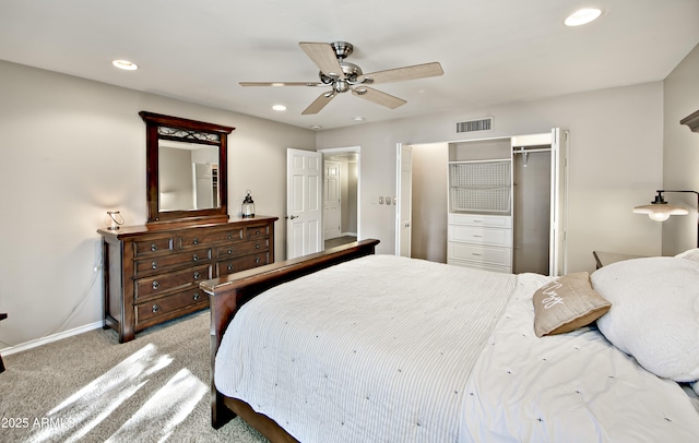 carpeted bedroom featuring ceiling fan and a closet