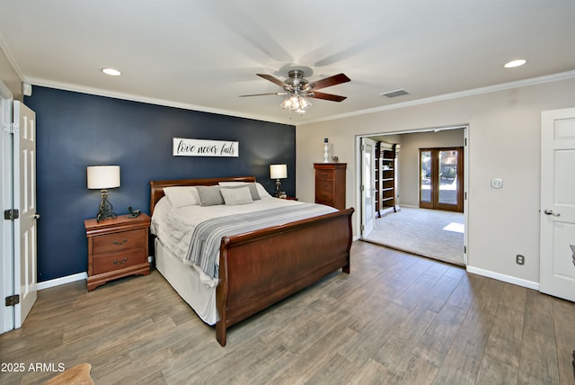 bedroom featuring crown molding, hardwood / wood-style floors, ceiling fan, and french doors