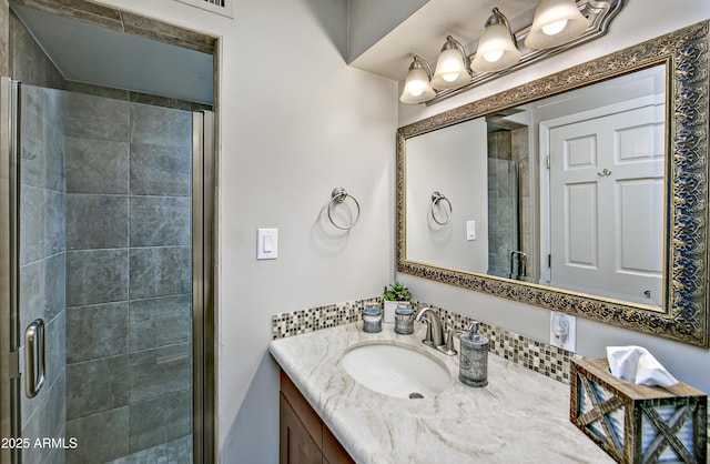 bathroom featuring vanity and an enclosed shower