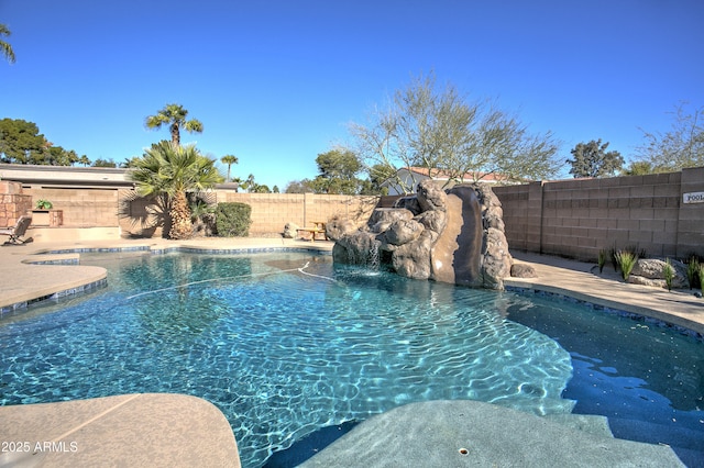 view of swimming pool with pool water feature