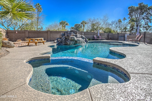 view of swimming pool with a patio and pool water feature