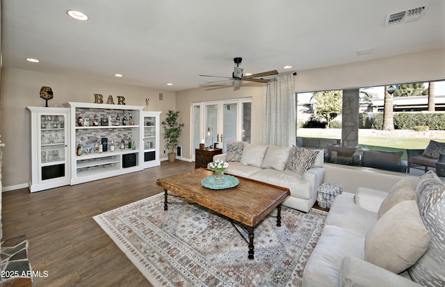 living room featuring hardwood / wood-style flooring, french doors, and ceiling fan