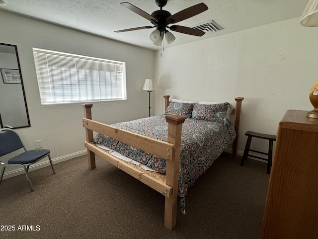 bedroom with ceiling fan, a textured ceiling, and dark colored carpet