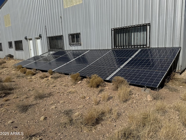 view of property exterior featuring solar panels