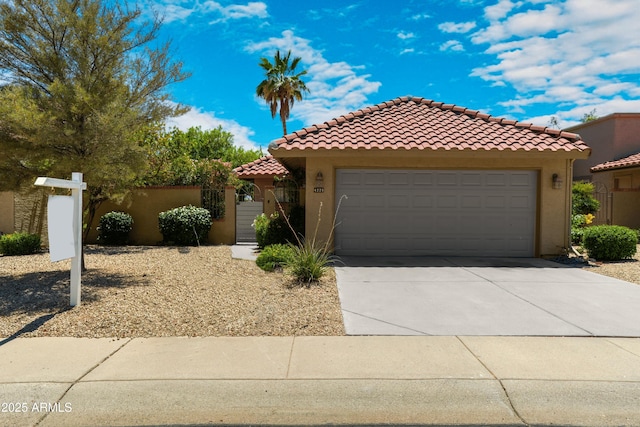 4225 E Sandia St, Phoenix, AZ 85044 - mediterranean / spanish-style house featuring stucco siding, driveway, a tile roof, an attached garage, and a gate