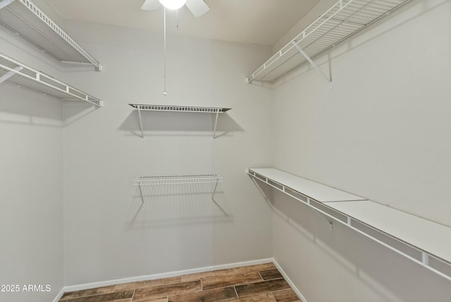 walk in closet featuring ceiling fan