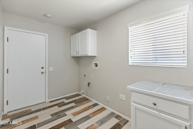 laundry room with light hardwood / wood-style flooring, cabinets, washer hookup, hookup for an electric dryer, and gas dryer hookup