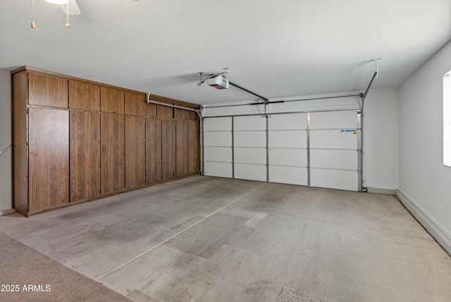 garage with a garage door opener and ceiling fan