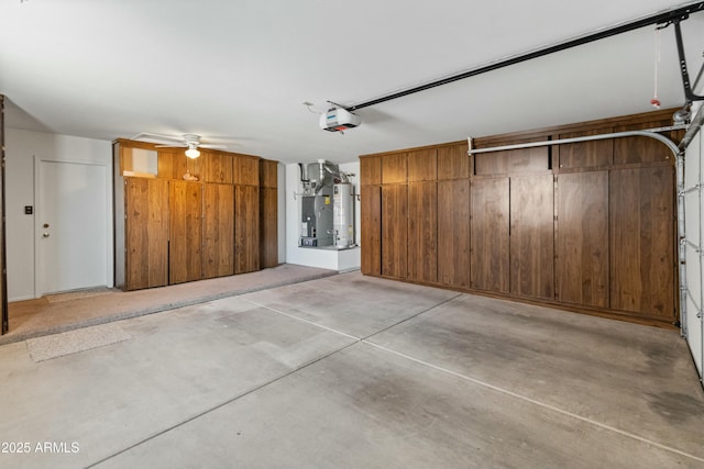 garage with ceiling fan, water heater, and a garage door opener