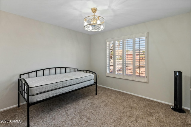 carpeted bedroom with a notable chandelier