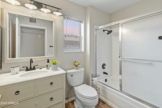 full bathroom with toilet, vanity, shower / bath combination with glass door, and hardwood / wood-style flooring