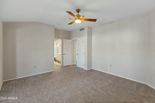 unfurnished bedroom with ceiling fan, ensuite bathroom, and carpet