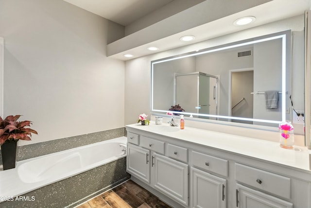 bathroom with vanity and plus walk in shower