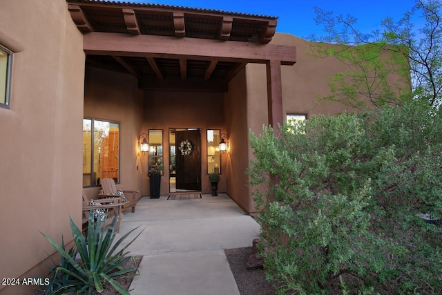 property entrance featuring a patio