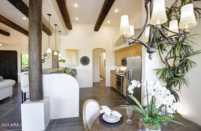 tiled dining area featuring beamed ceiling and a towering ceiling