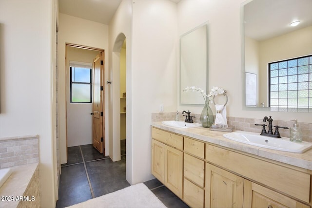 bathroom with tile patterned floors and vanity