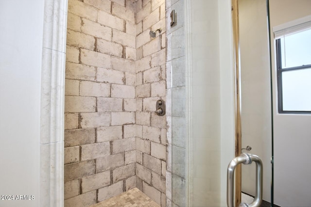 bathroom with a shower with door