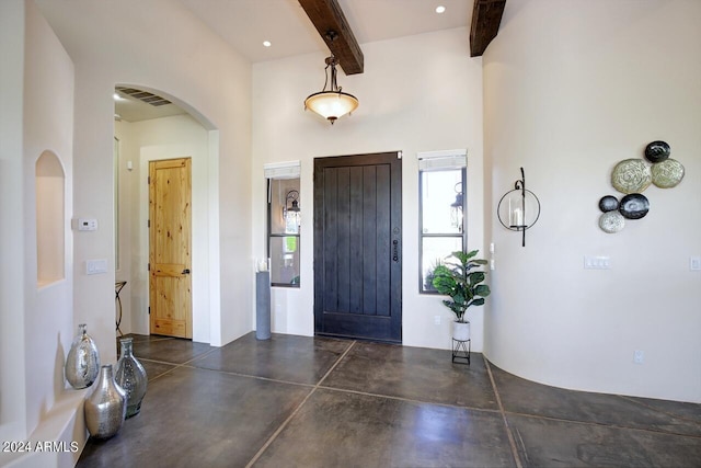 entrance foyer featuring beam ceiling