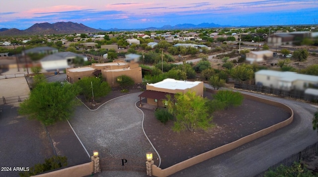 aerial view at dusk featuring a mountain view