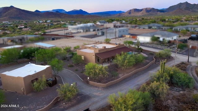 aerial view at dusk featuring a mountain view