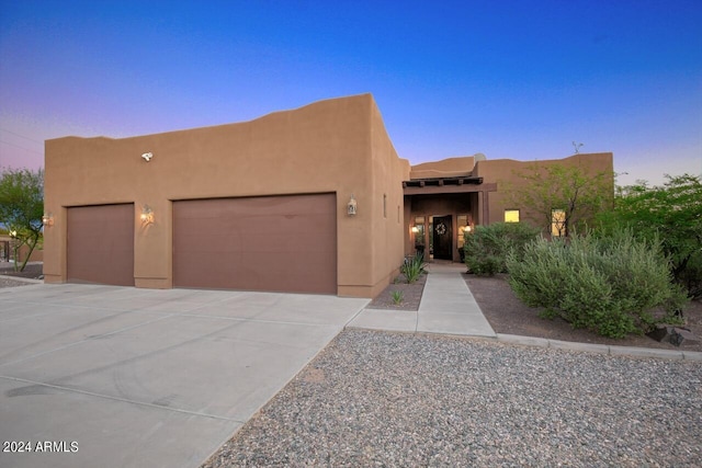 adobe home featuring a garage