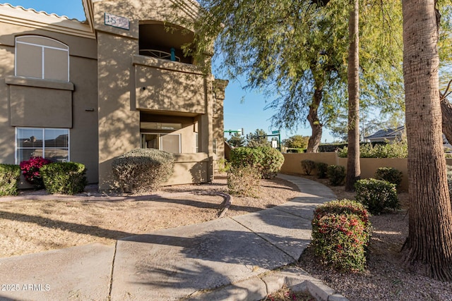 view of side of property featuring a balcony