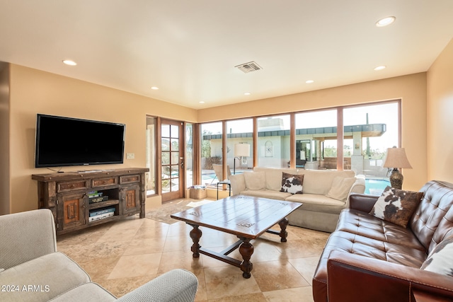 tiled living room featuring french doors and a wealth of natural light