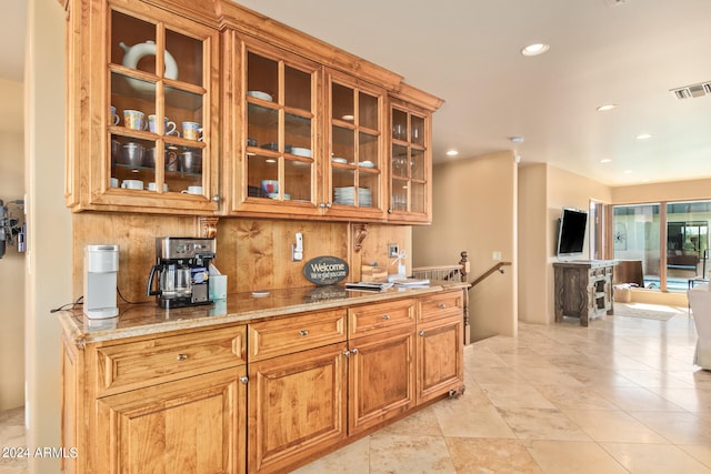 kitchen with light stone countertops and light tile floors