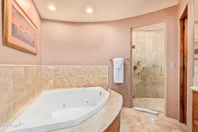 bathroom featuring shower with separate bathtub and tile flooring