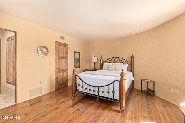 bedroom with hardwood / wood-style floors