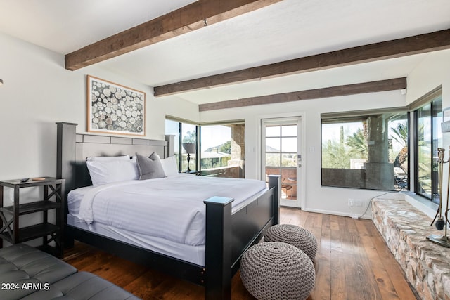 bedroom featuring wood-type flooring and beamed ceiling