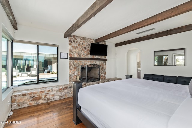 bedroom featuring multiple windows and dark hardwood / wood-style flooring